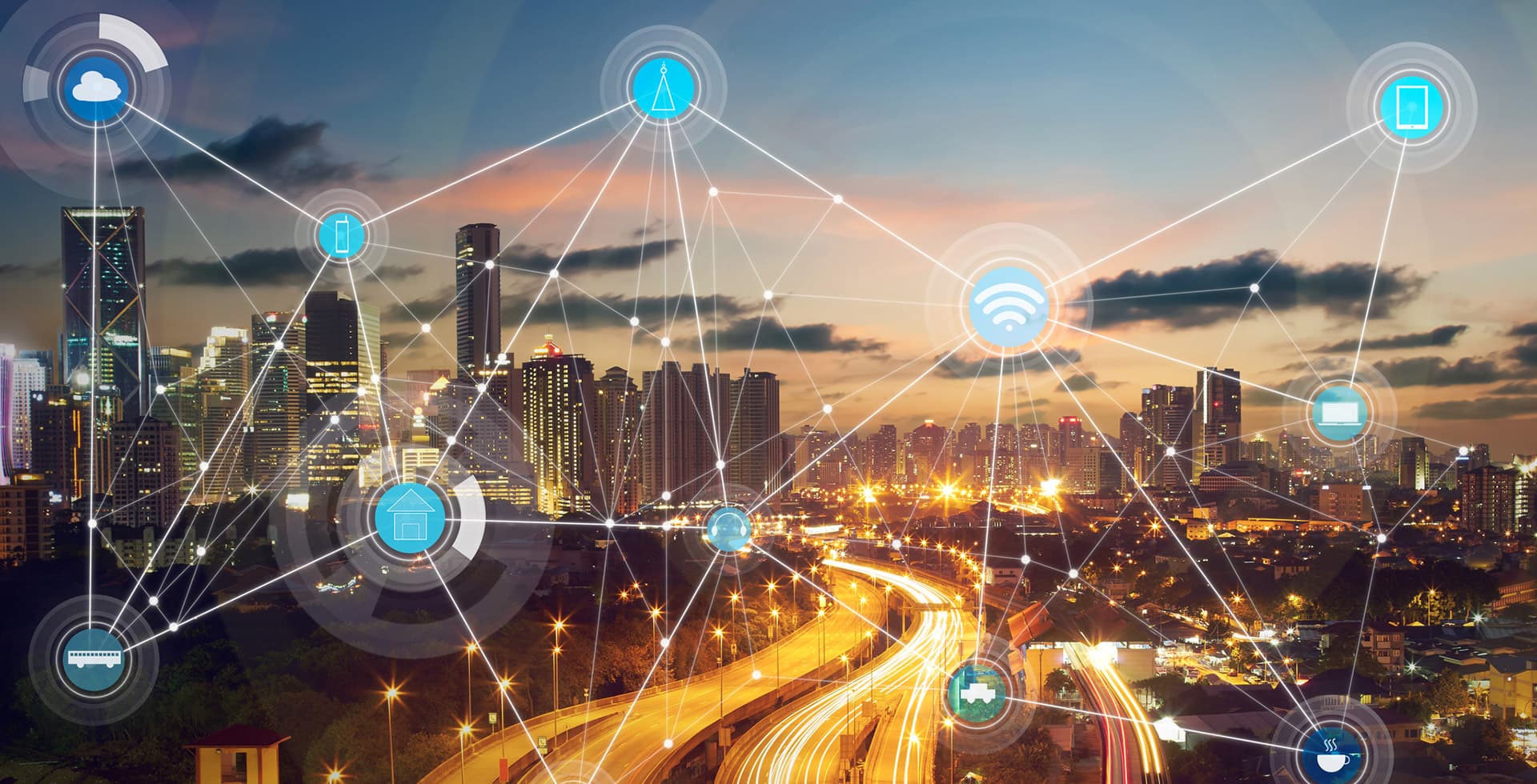 Abstract connected IoT icons on a cityscape at night.