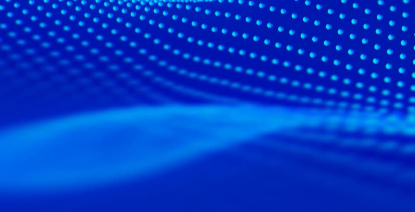 Vague de points lumineux cyan sur un fond bleu.
