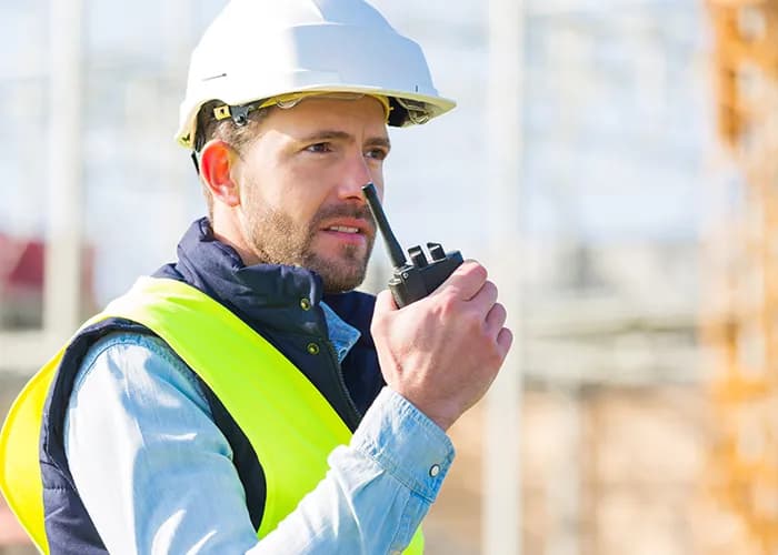 Construction worker using walkie-talkie