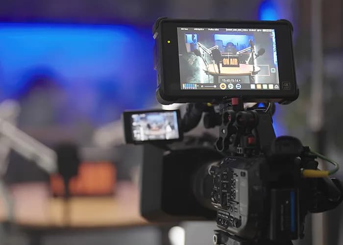 A broadcast camera operator filming a live event.