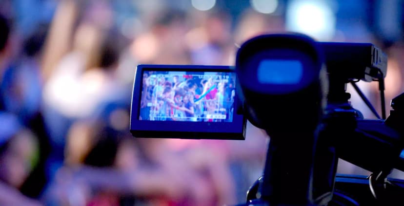 Man recording a video, monitored on a tablet.