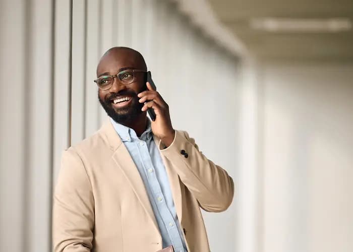 Businessman smiling during a phone call in an office.