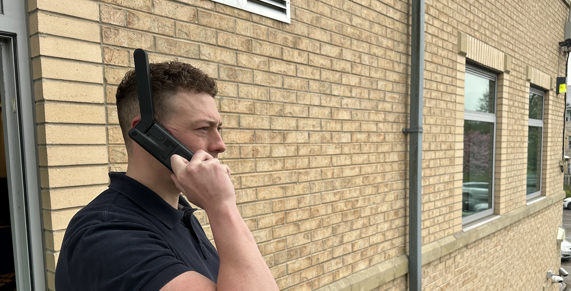 Man using satellite device outside office