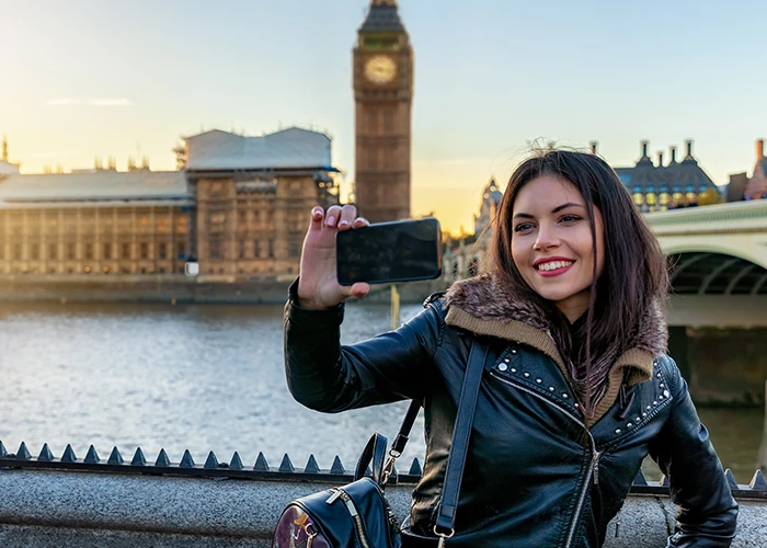 Image of a woman taking a selfie near Westminster, London